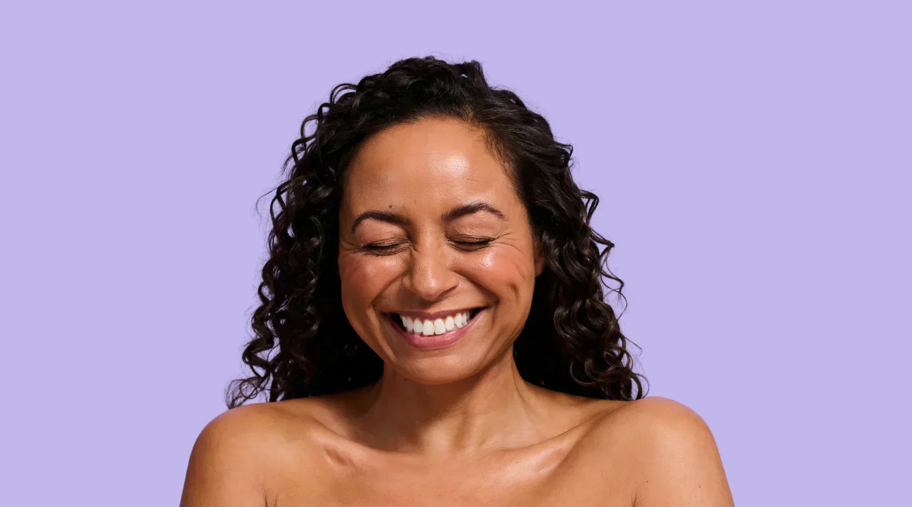 Model smiling wearing Super Facialist products