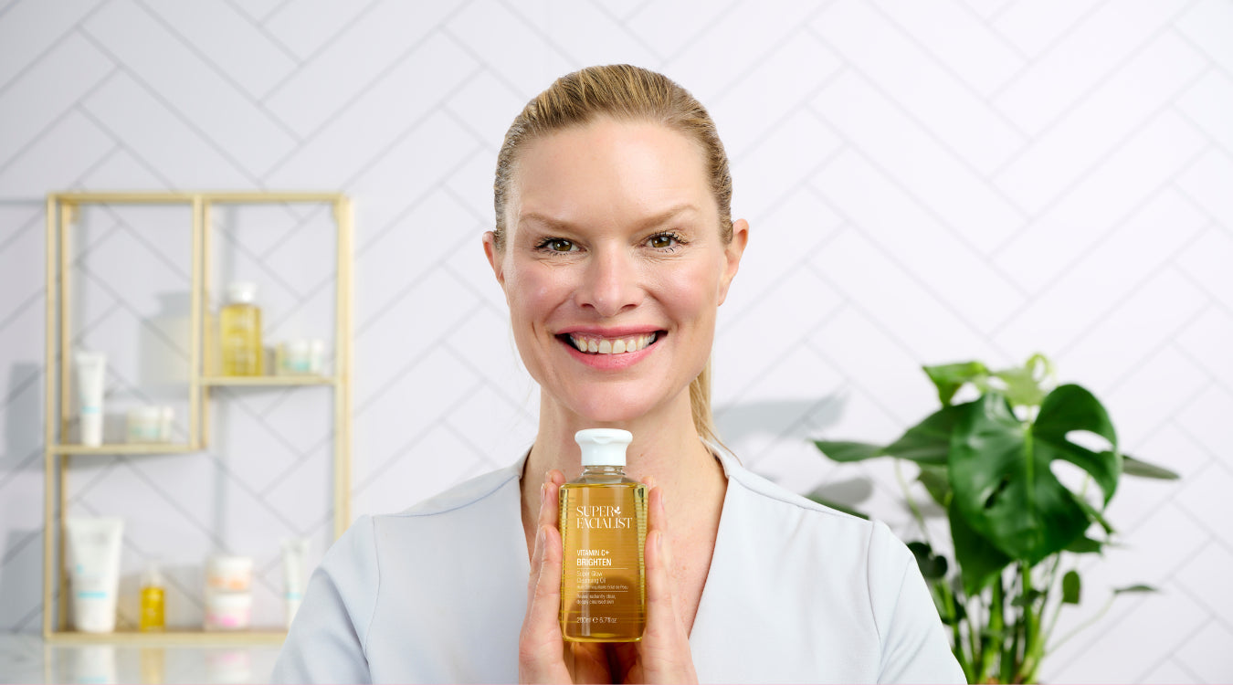 charlotte connoley holding cleansing oil bottle under her chin