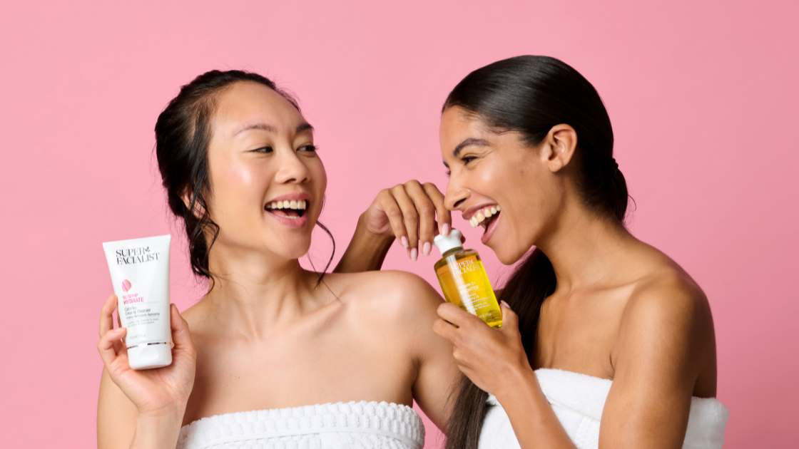 Two models holding salicylic acid moisturiser and vitamin c moisturiser