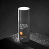Serum tube in a dark setting with high contrast shadow lighting. 