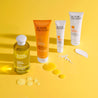 Super Facialist Vitamin C Range products line dup next to eachother with their textures swatched next to each pack.