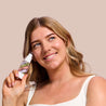 Model holding the Skin Perfecting Primer in Fair-Light