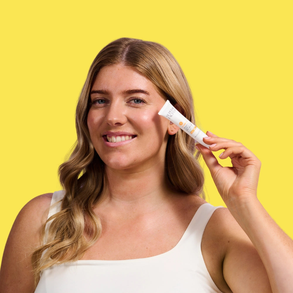 Model holding Vitamin C+ Brighten Eye Cream