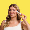 Model holding Vitamin C+ Brighten Eye Cream