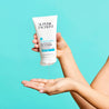 Hand squeezing the tube of clear gel cleanser onto hand