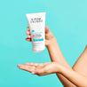 hand squeezing the tube of clear gel cleanser onto hand