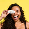Model holding Vitamin C+ Brighten & Defend Serum SPF50+