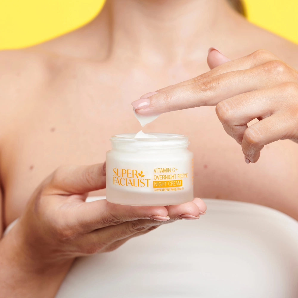 Vitamin C Night Cream jar being dipped with 2 fingers