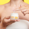 Vitamin C Night Cream jar being dipped with 2 fingers