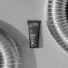 grey tube with red symbol on metalic background between two metal tubes
