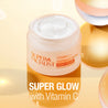 Open jar with cream inside against a glass mirror background. "SUPER GLOW with Vitamin C" text overlay.