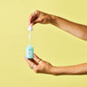 Hand holding the Dropper glass bottle