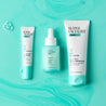 Spot gel, serum and daily moisturiser laid out on blue liquid