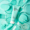 Clear Skin Clarifying Mask Light blue tube surrounded by measuring glass and blue liquid