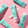 Clear Skin Clarifying Mask Light blue tube on top of a swatch of the face mask on pink table