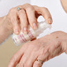 Hand pumping out hexapeptide 9 serum onto the back of another hand