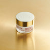 Anti-ageing eye cream jar on gold table 