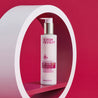 Hexapeptide cleansing milk pump bottle inside a white circular prop with red background