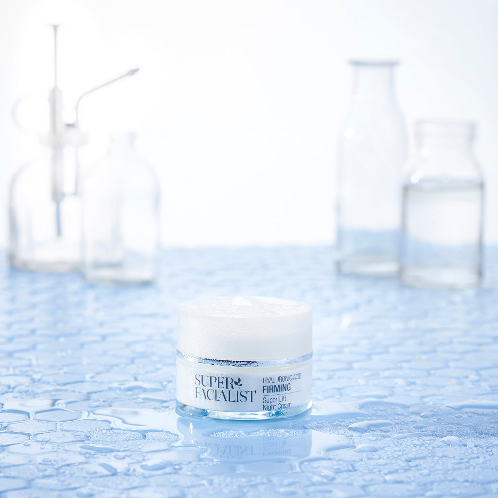 Hyaluronic acid night cream jar inside a lab with water droplets around it