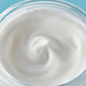 White cream swirled inside the night cream jar close up