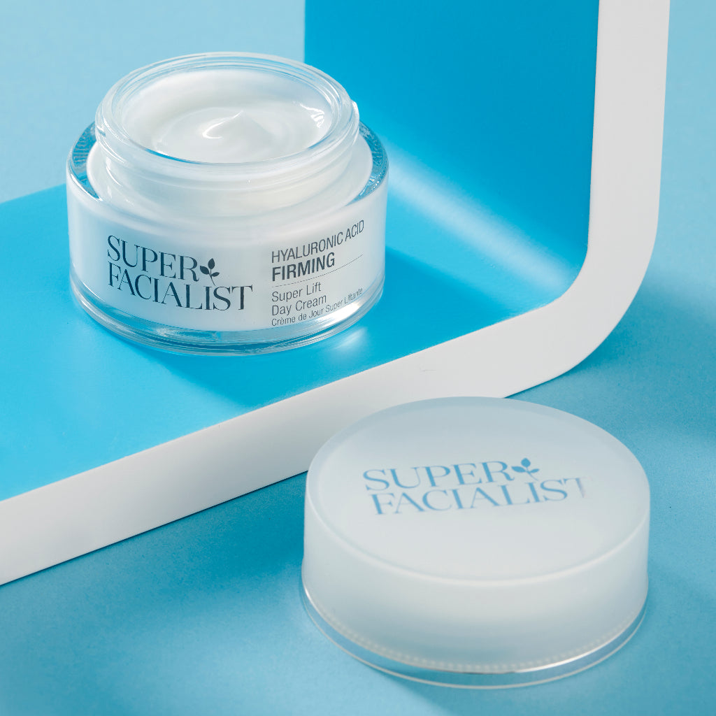 Hyaluronic acid night cream jar opened inside a white and blue square prop with the lid open