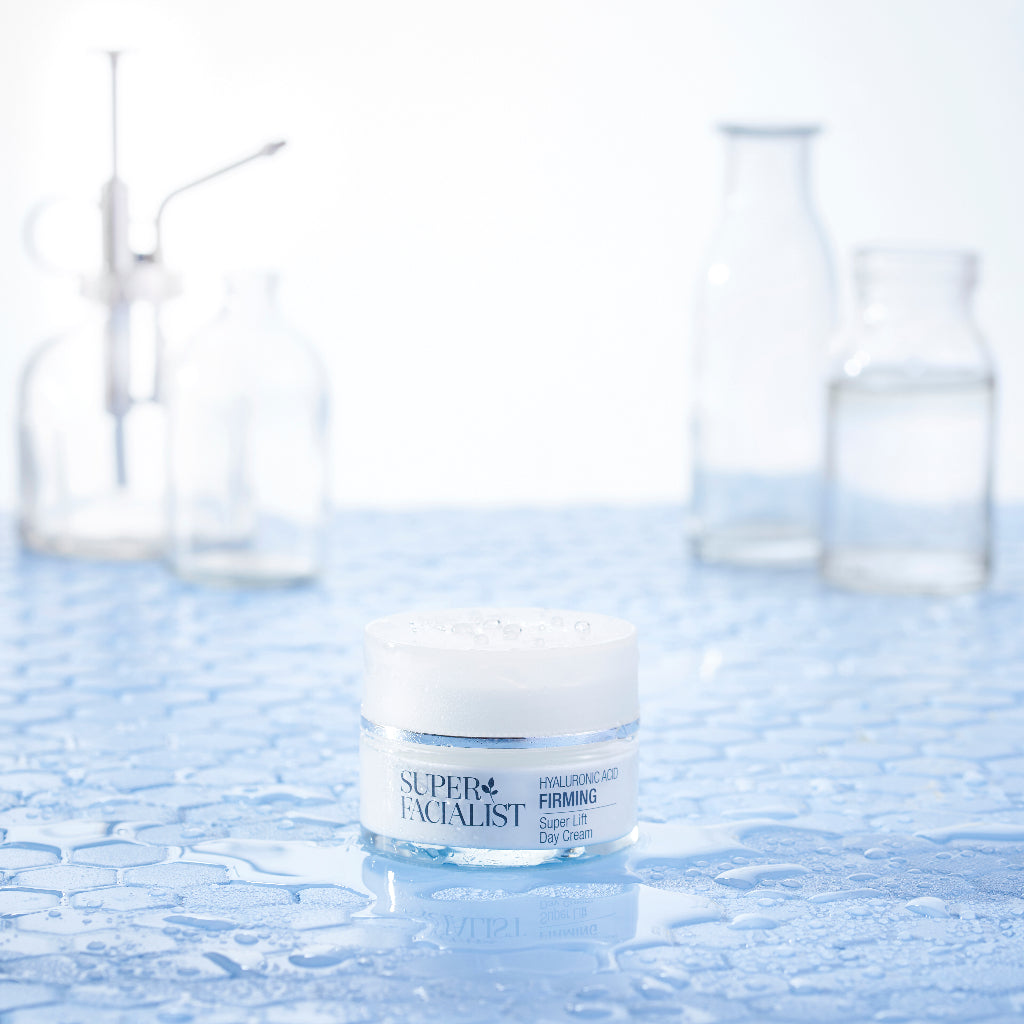 Hyaluronic acid night cream jar in a lab with water droplets around the jar