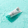 Daily Moisturiser on water on top of turquoise table
