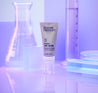Retinol eye cream tube inside a purple coloured lab