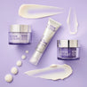 Retinol anti ageing range of day cream, facial serum and night cream laid out on a purple table