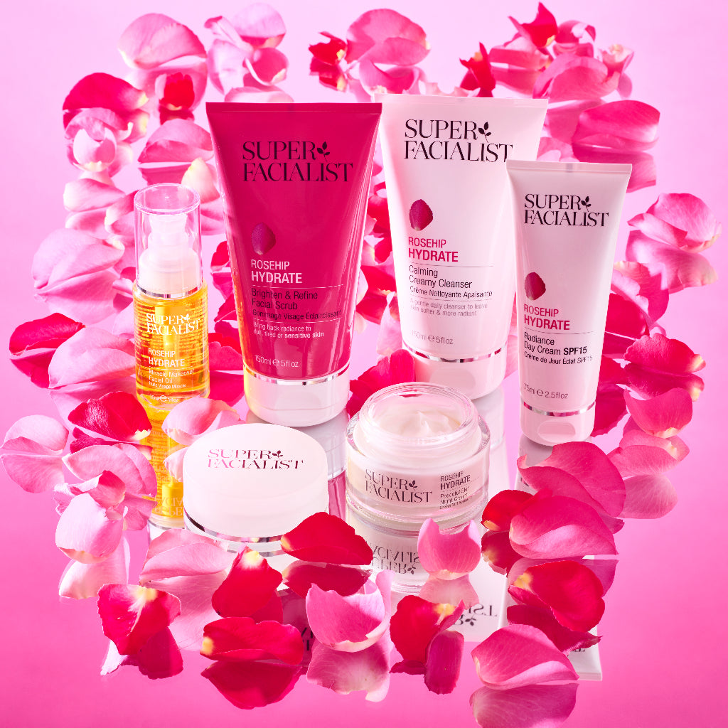 Full Super Facialsit Rosehip range standing on a pink mirror table surrounded by rose petals
