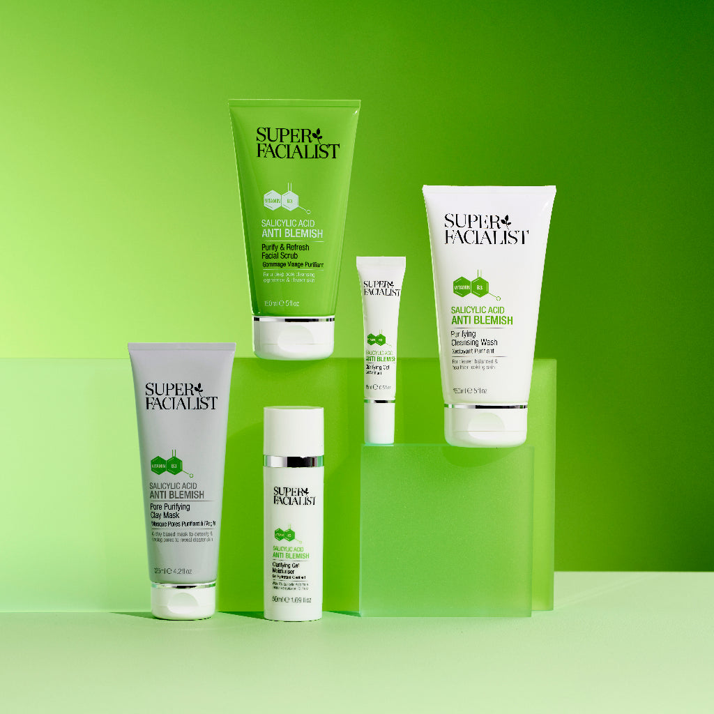 Full salicylic acid range of cleansing wash, facial scrub, clay mask, gel moisturiser and spot gel on green cubes