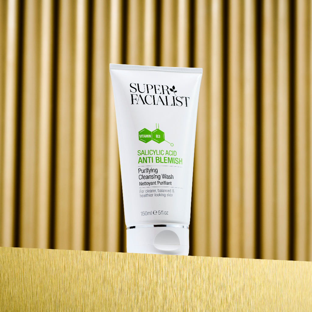 Anti blemish cleansing wash on gold table and gold background
