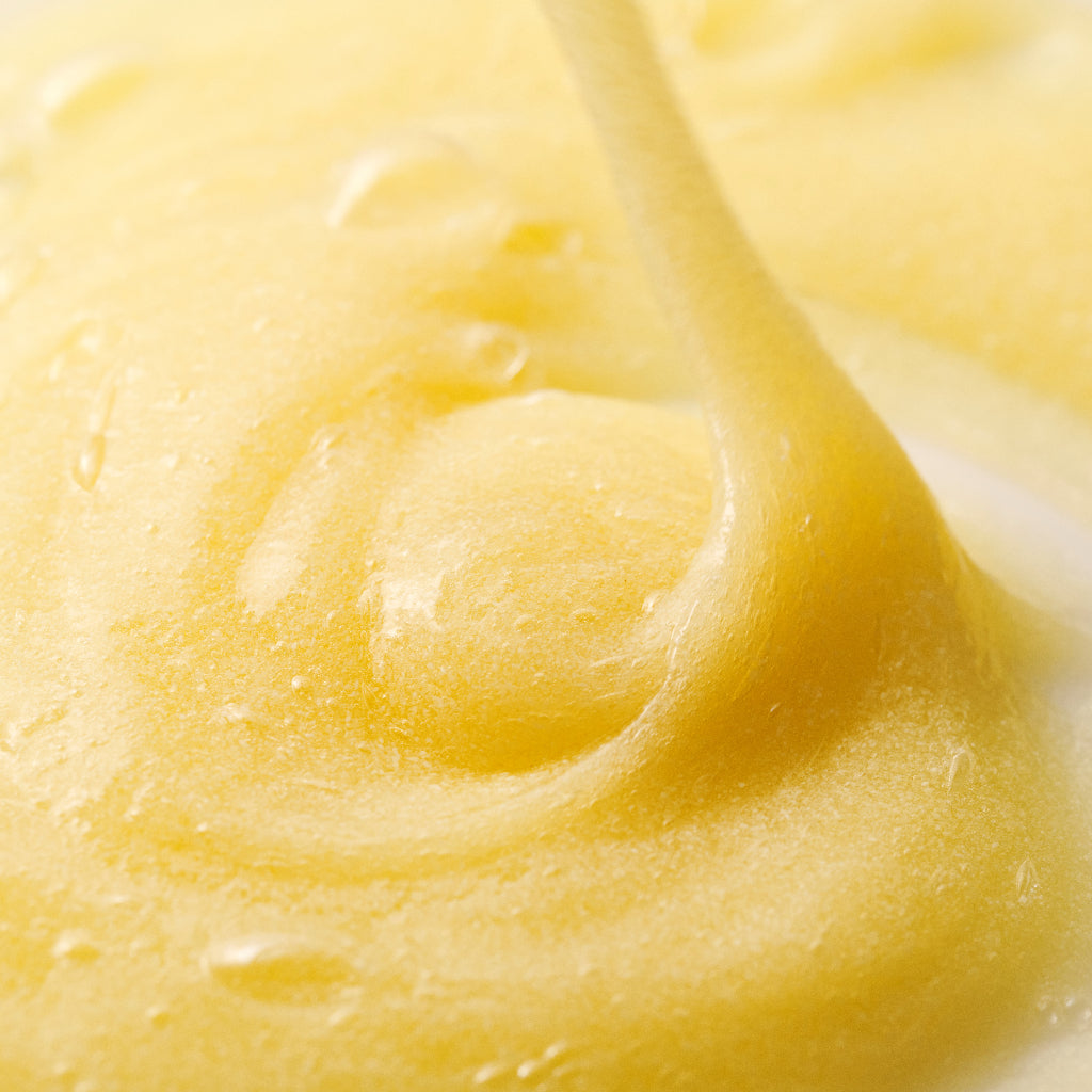Vitamin C micro polish texture close up shot swirling yellow thick liquid 