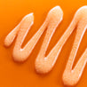 Vitamin c polish wash liquid texture close up with white microbeads
