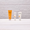Vitamin C daily polish wash and skin serum and daily mosituriser on white table and white brick background wall